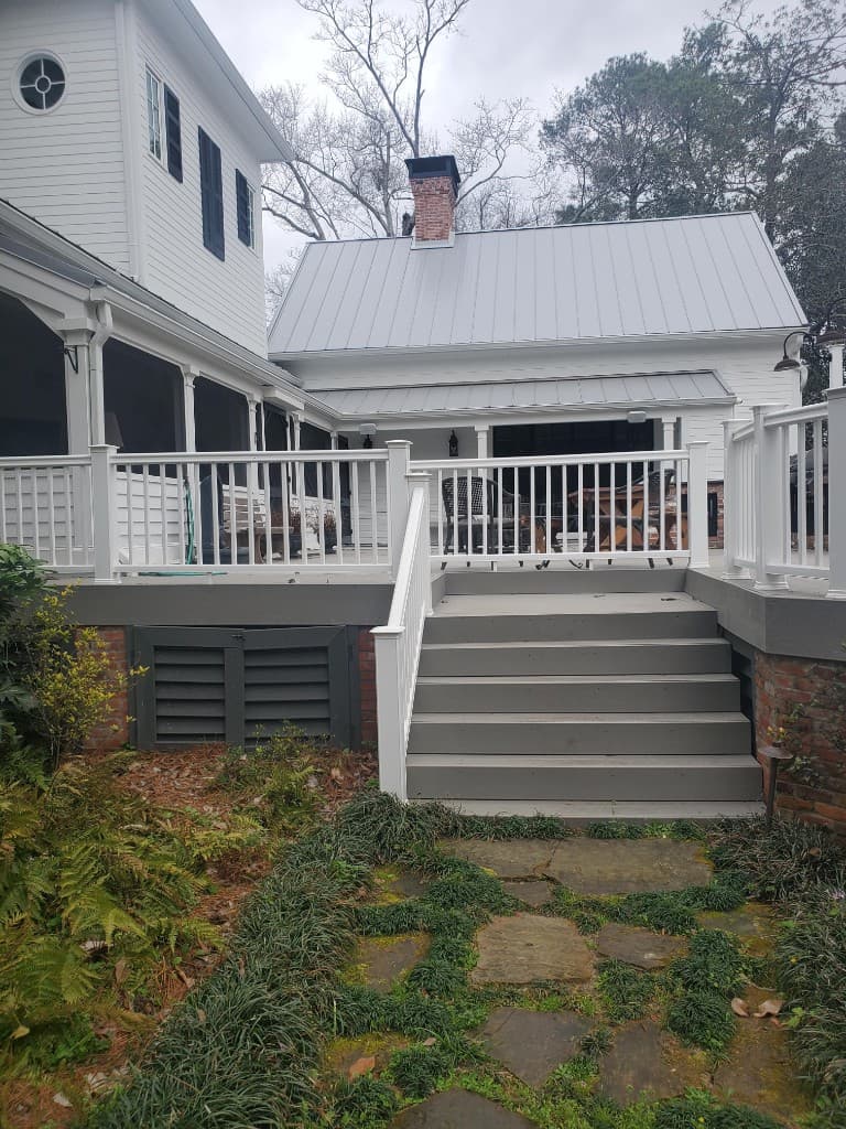 Staircase and living area opened up with updated railing and finishes